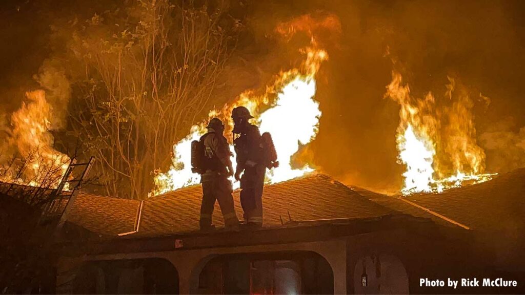 Firefighters on roof at California house fire