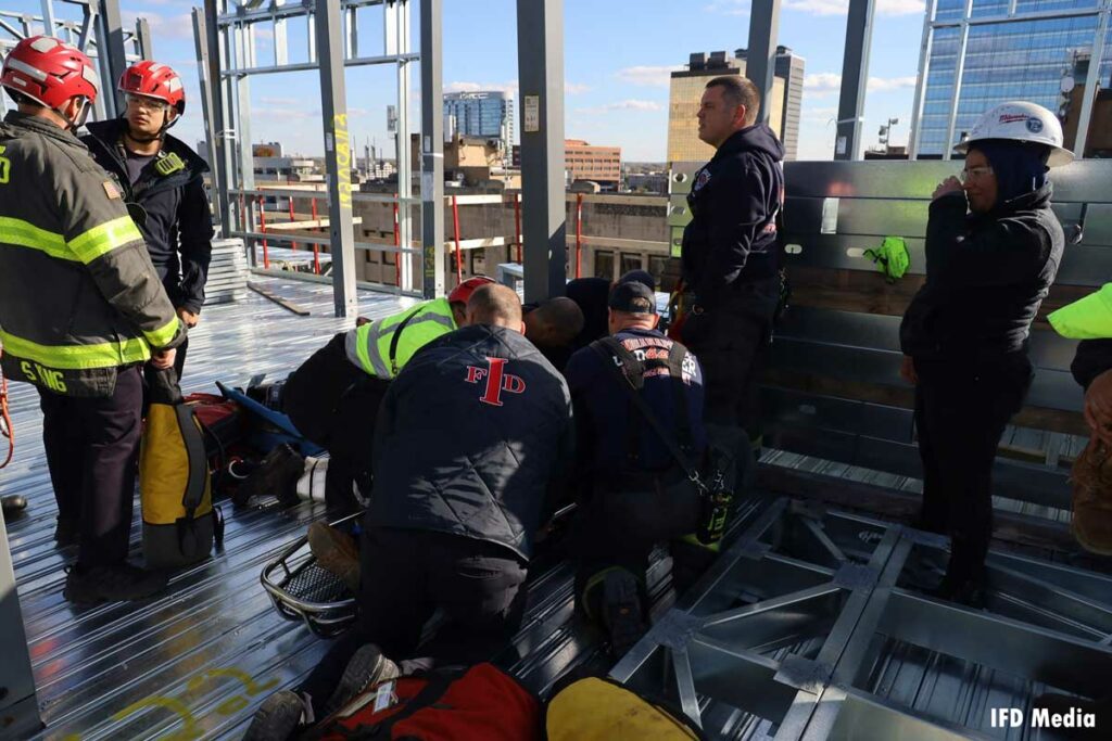 Indianapolis firefighters load patient onto stokes basket