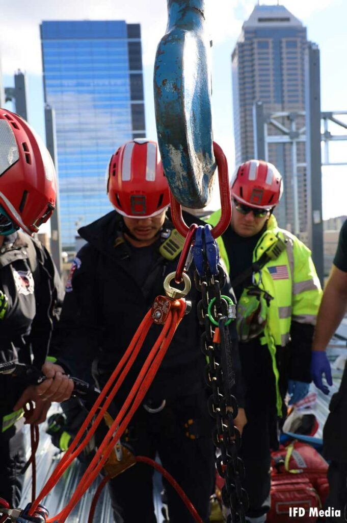 Patient is rigged up to rope system high above the street