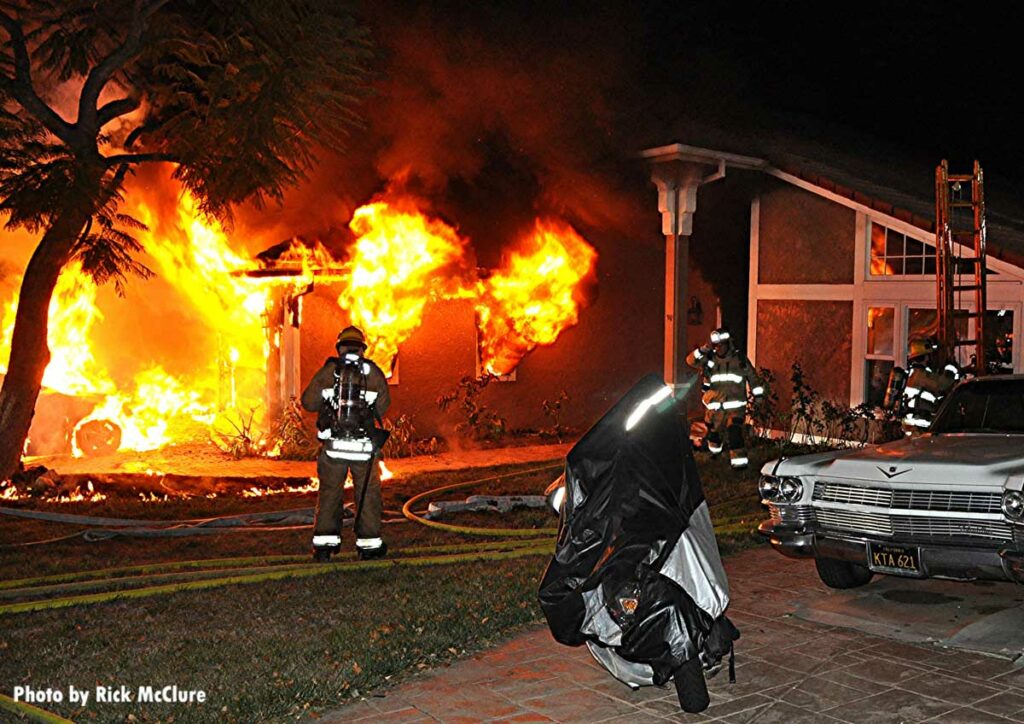 Firefighter with SCBA as flames roar in the background