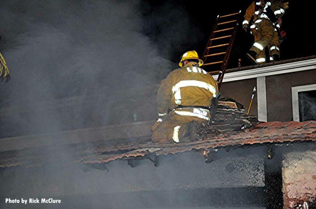 Firefighter on the roof with a ladder