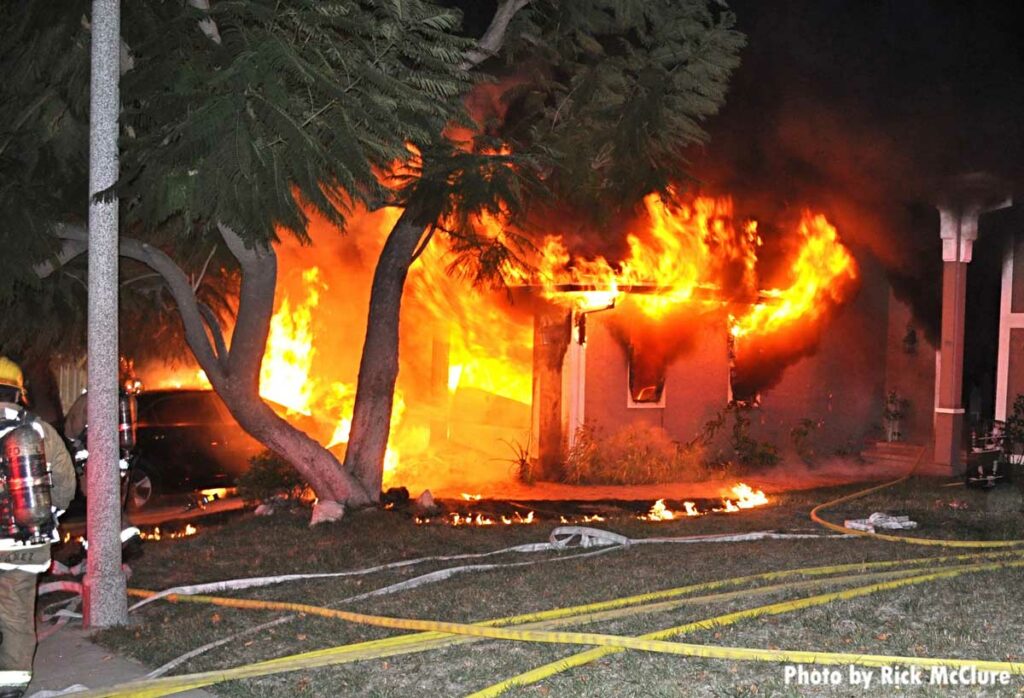 Flames roar from an attached garage in California