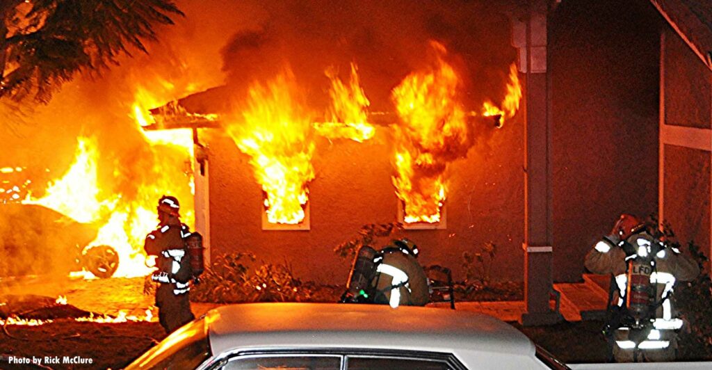 Flames out two windows of an attached garage