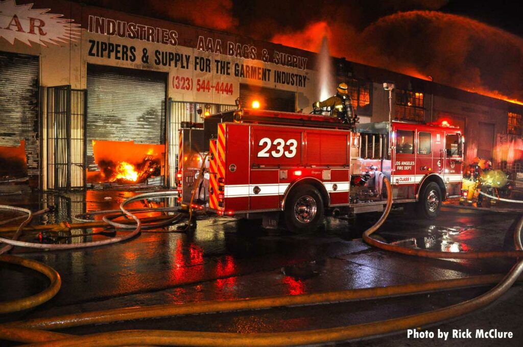 Firefighter with deck gun on top of LAFD fire truck