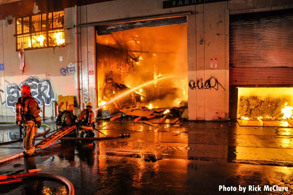 Fire exposed through large roll-down gates at commercial fire in Los Angeles