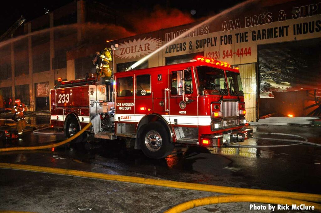 Firefighter on fire engine at Los Angeles commercial fire