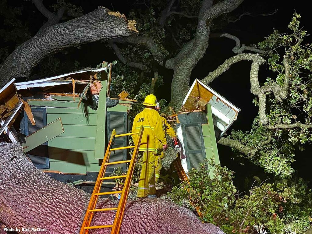 LAFD firefighters ascend ladder to crushed home