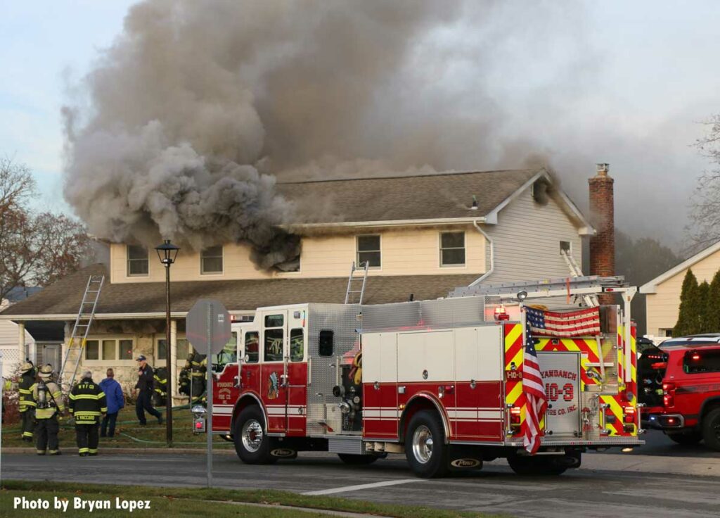 Smoke emerges from home on Long Island with fire apparatus out front