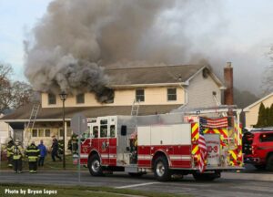 Smoke emerges from home on Long Island with fire apparatus out front