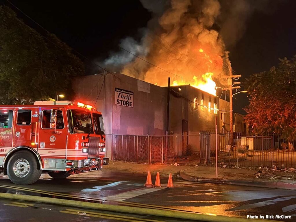 LAFD fire truck pulls up to well-involved commercial building