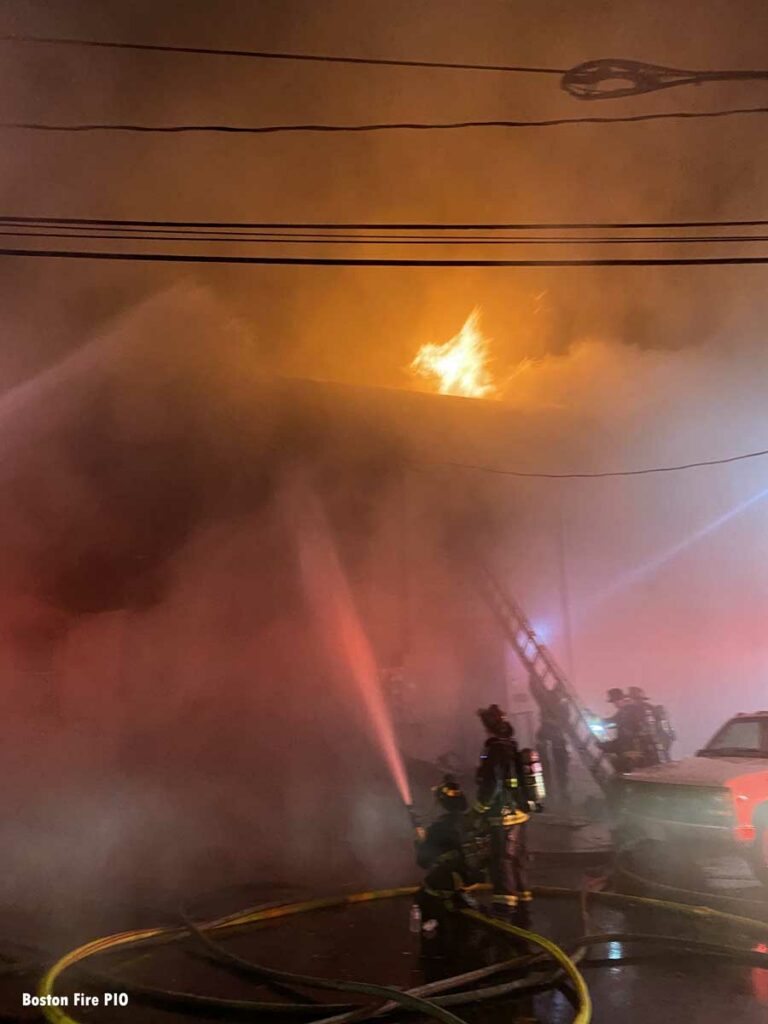 Firefighters with exterior hoselines at commercial fire in Boston