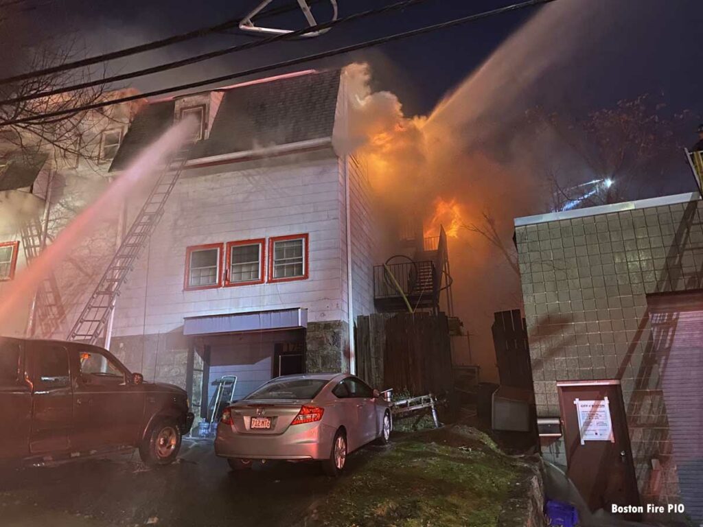 Fire shoots from a commercial building in Brighton section of Boston