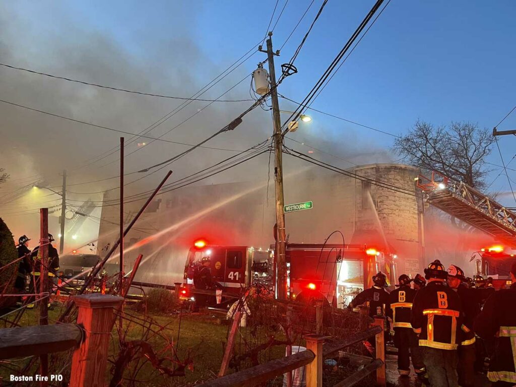 Hose streams and Boston firefighters at major fire scene