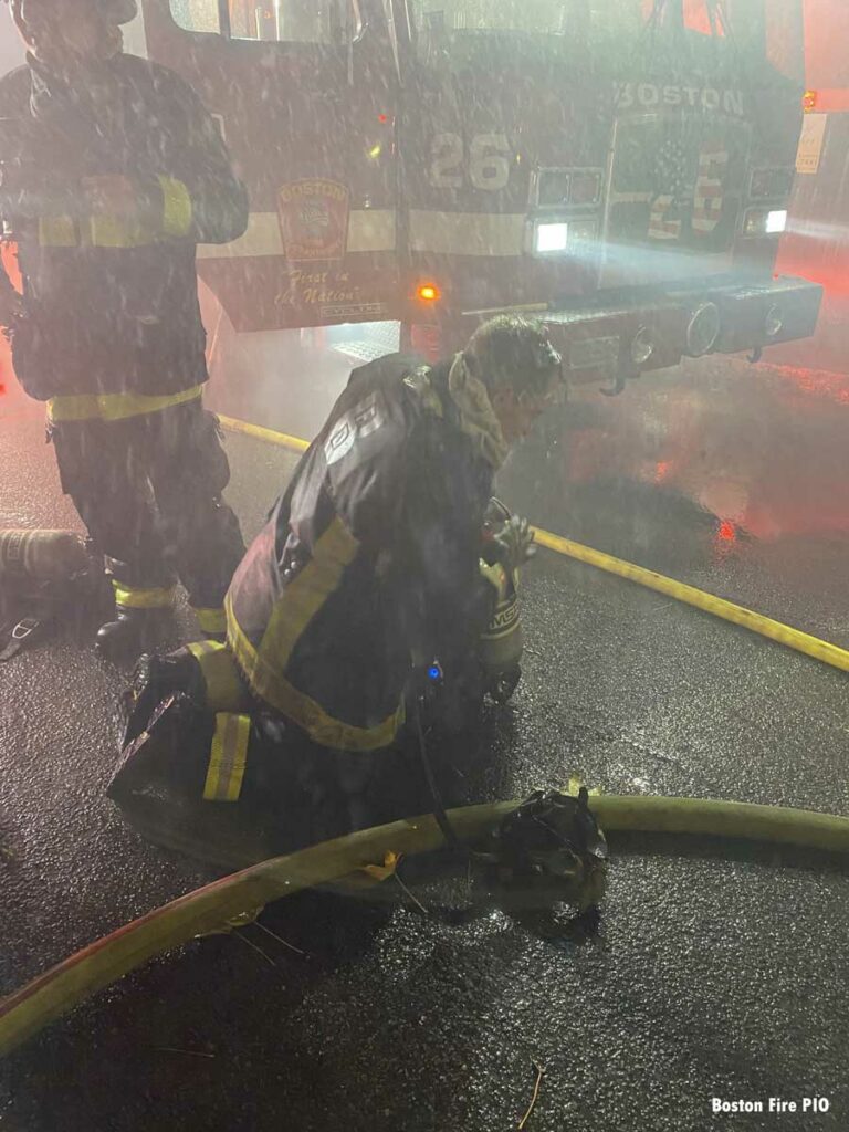 Firefighter putting on SCBA at Boston fire