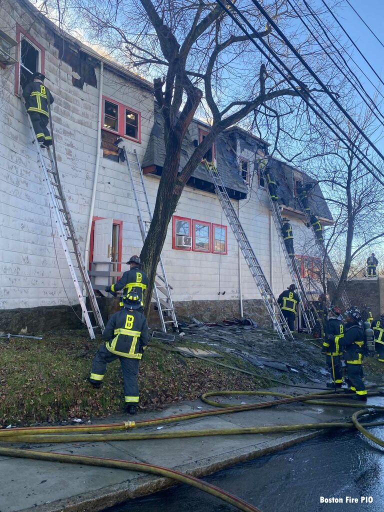 Boston firefighters use multiple ladders at fire scene