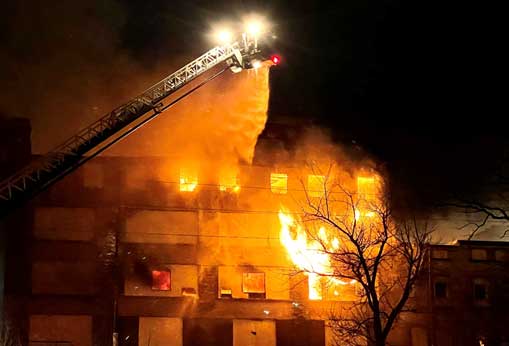 Aerial and flames on exterior of building