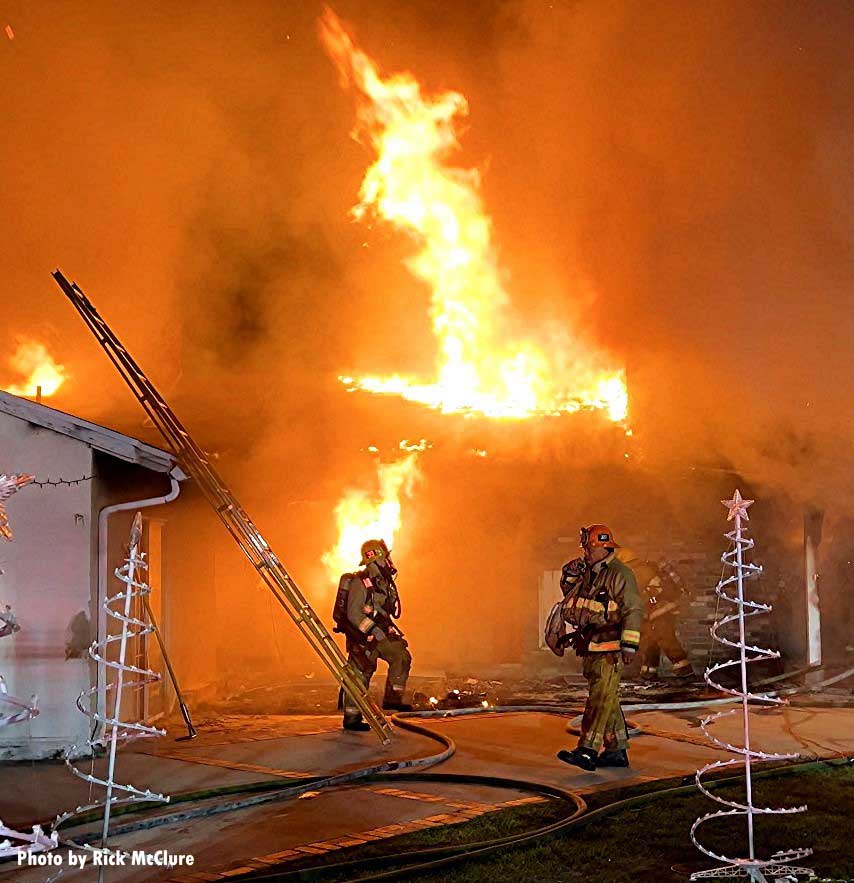 Los Angeles firefighters with ladder at house fire