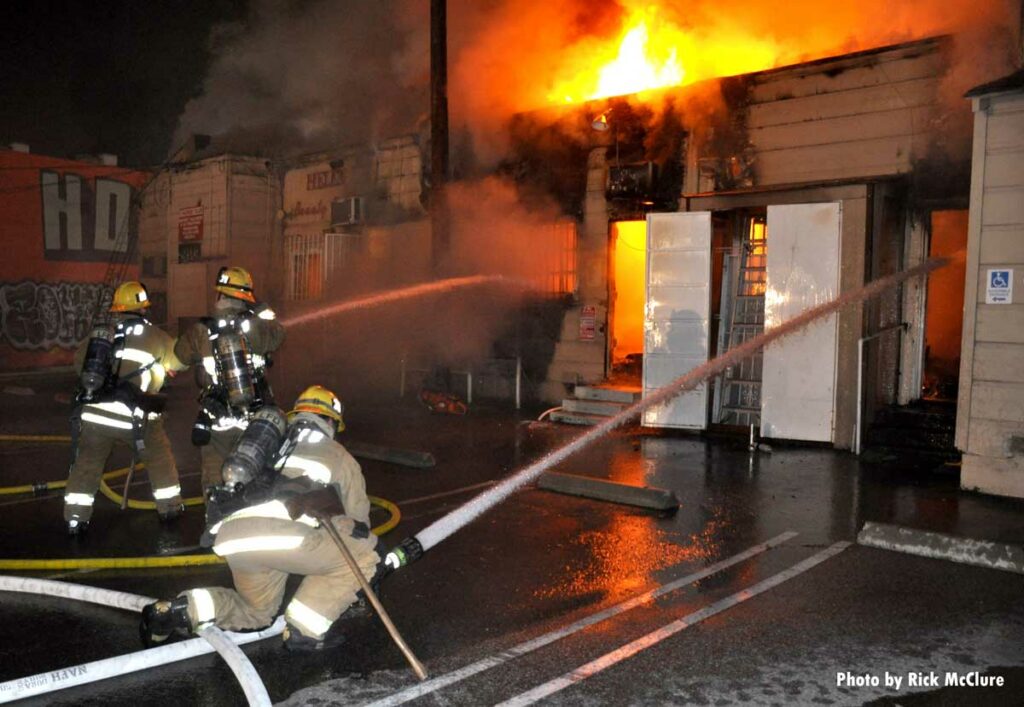 Firefighters put water from two hoselines into building