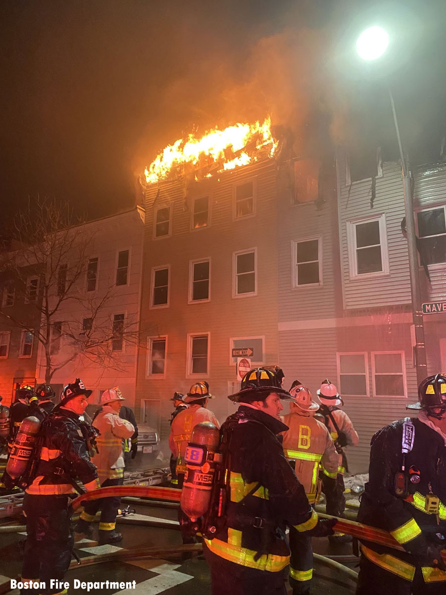 Flames tear from roof of Boston building as firefighters work