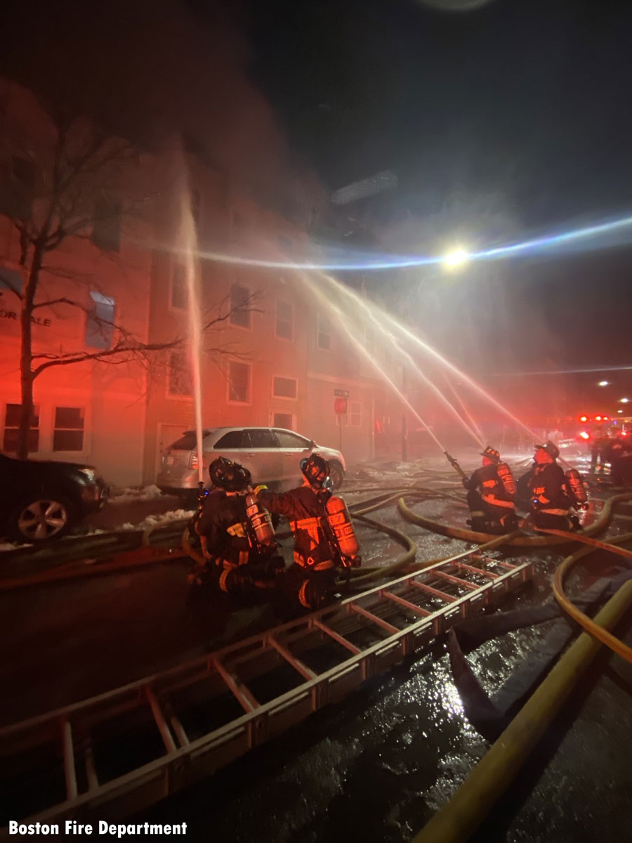 Four Boston fiirefighters use exterior hose streams