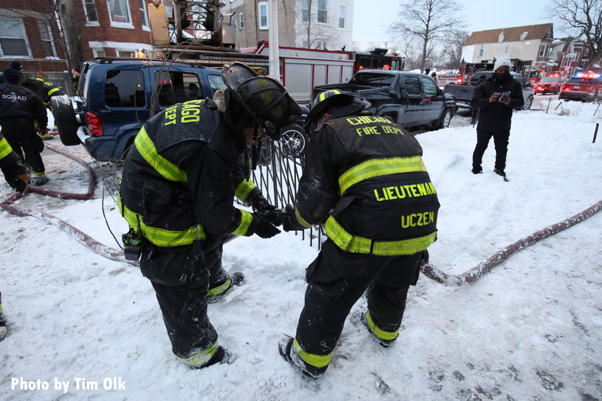 Chicago firefighters hook up hoses