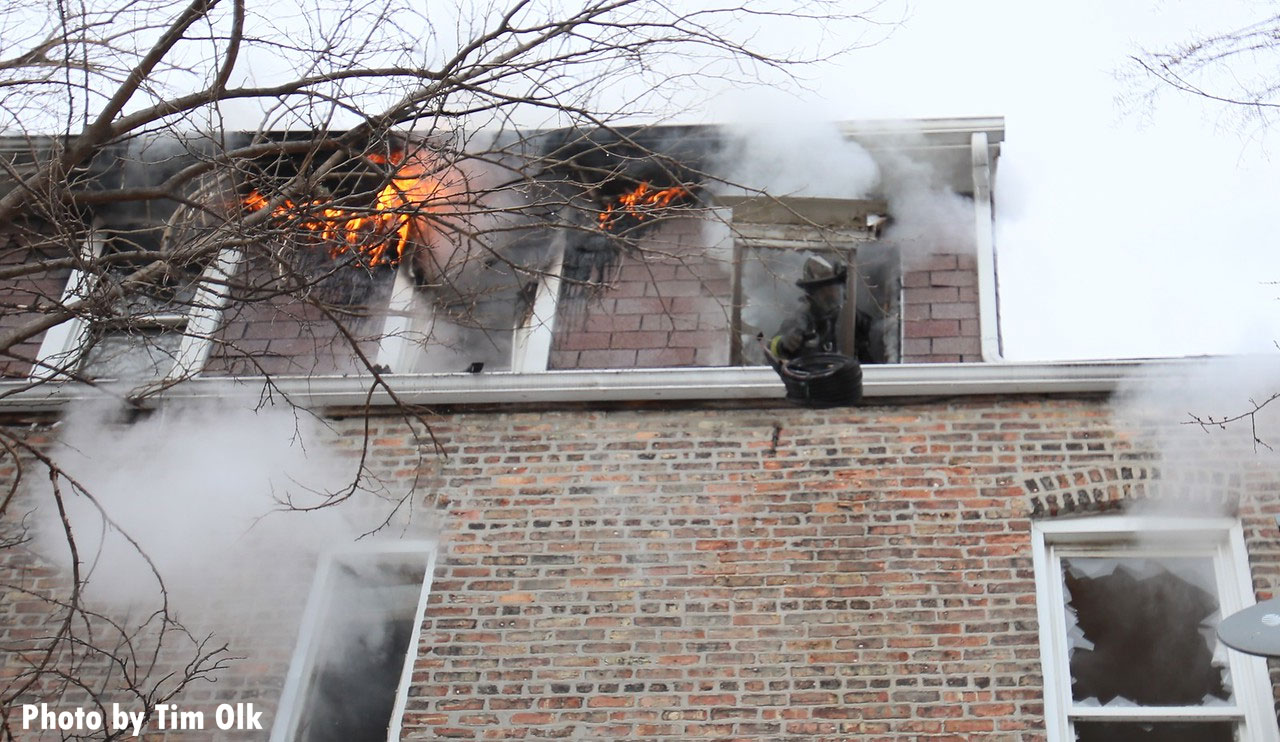 Flames with a Chicago firefighter looking out a window