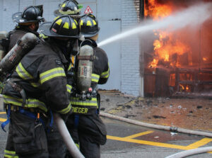 Firefighters putting water on fire