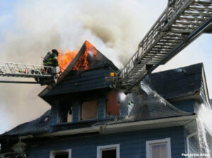 Firefighters on aerial with flames