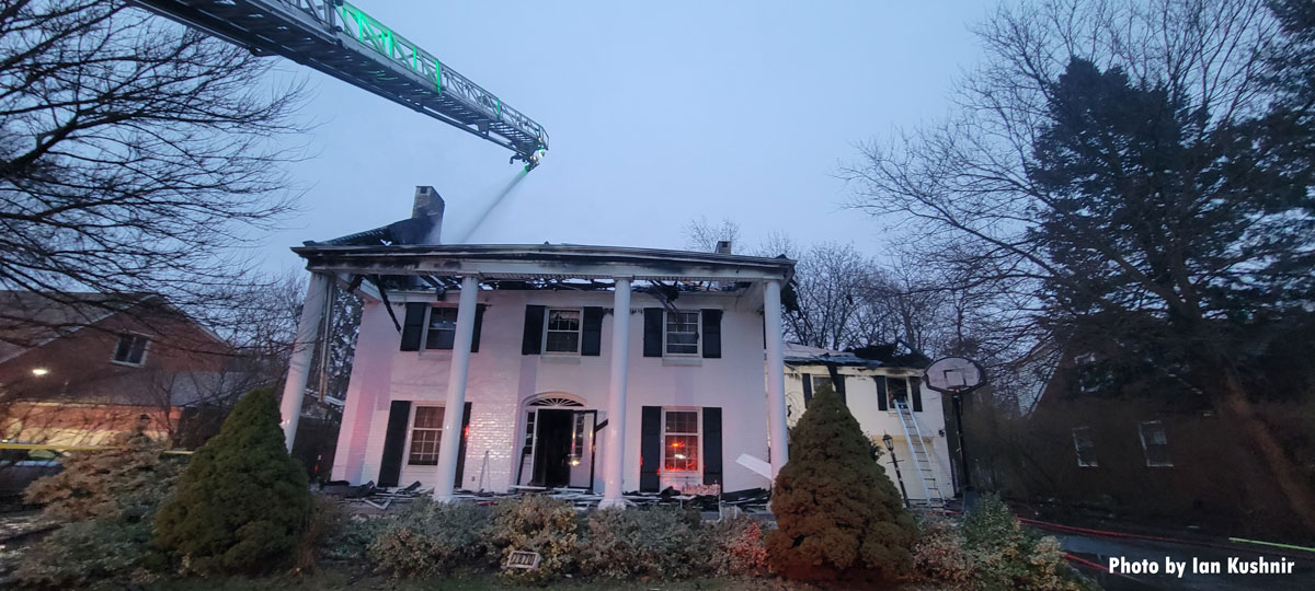 Aerial device over wrecked Dearborn house