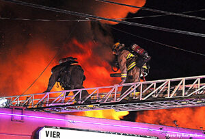 LAFD firefighters use aerial ladder to access roof