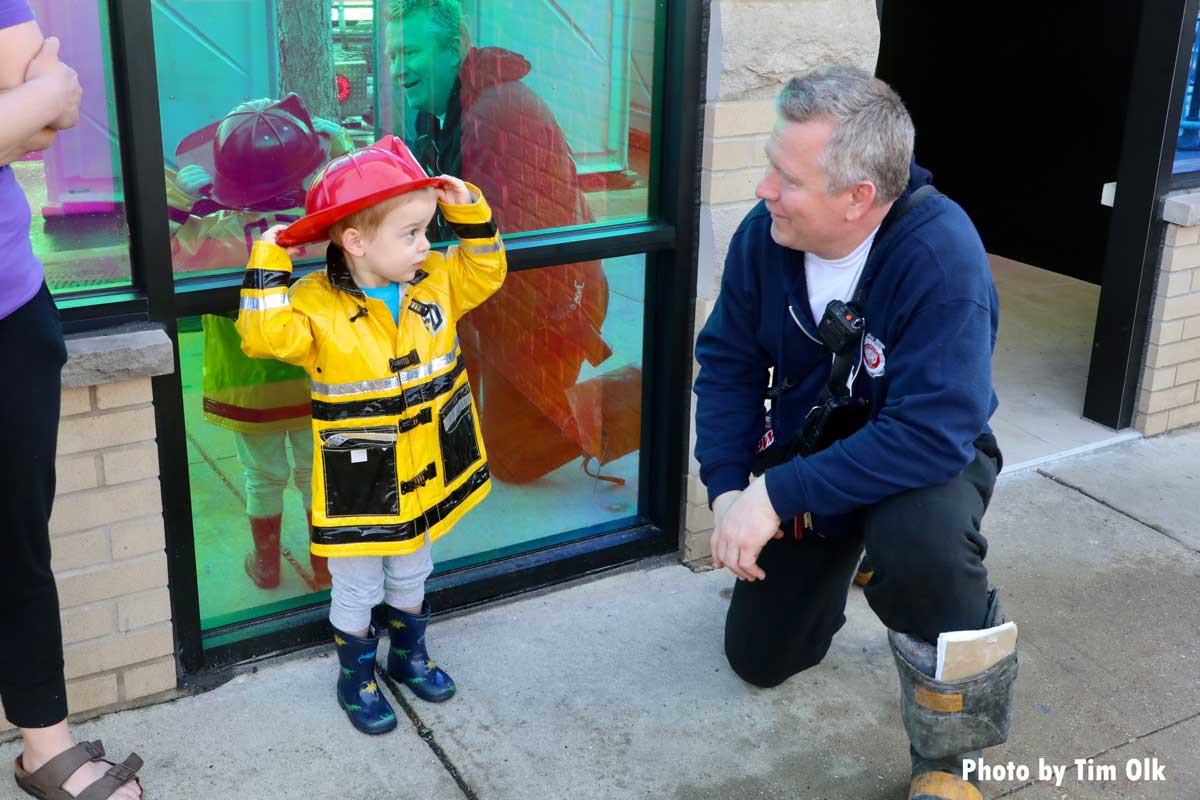 Kid in fireman costume with Chicago firefighter