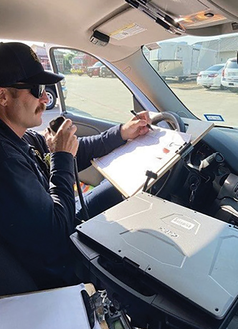 Battalion chief drivers/aides are an integral component of the “two-person command team.” Here, Battalion 1’s incident command engineer communicates with dispatch on the command channel, which frees up valuable radio time on the fireground channel.