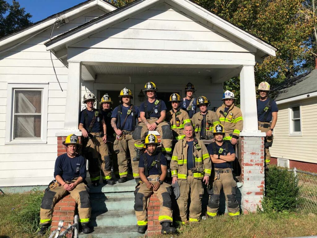 Firefighters on front stoop of house