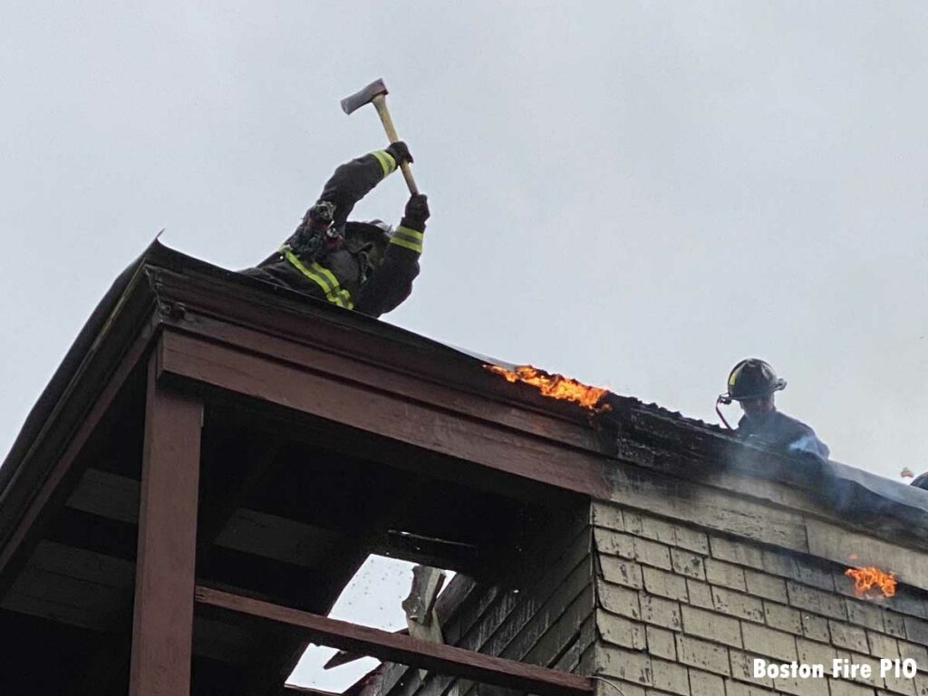 Boston firefighter with ax on roof