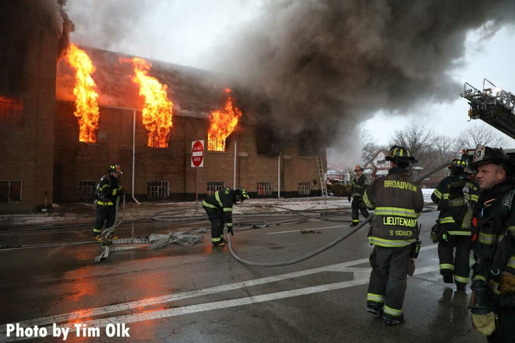 Firefighters stretch hoselines at Maywood church fire