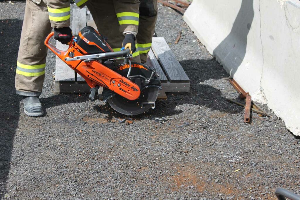 Firefighter cutting with rotary saw