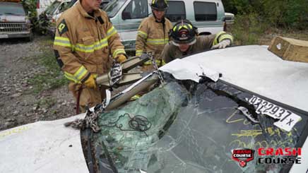 Firefighters using spreader vehicle rescue training