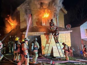 Syracuse firefighters operate at a house fire