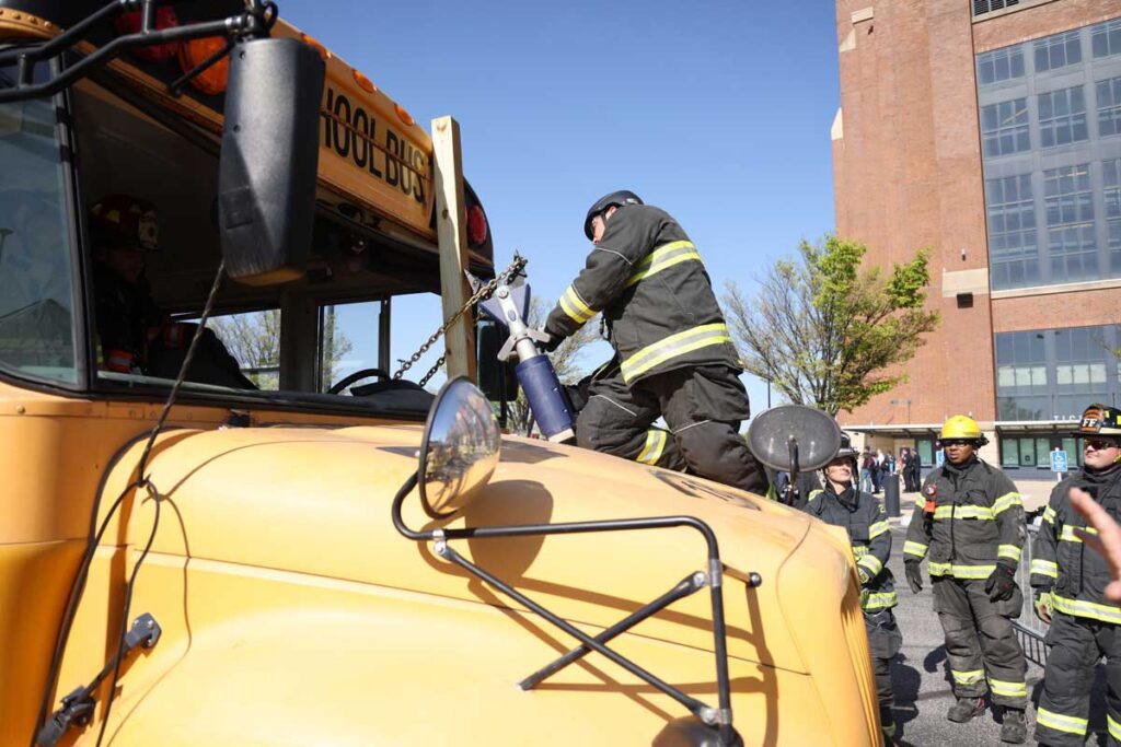 Firefighter with jaws of life on school bus