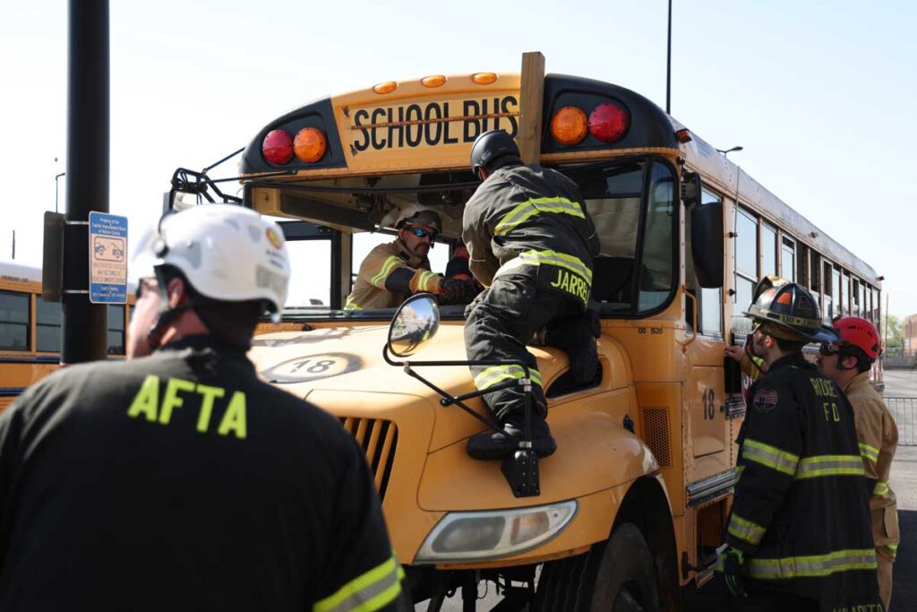 Firefighter on school bus roof