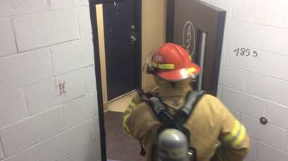 Firefighter opening a door