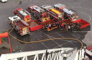 Firefighters seen from atop a tower ladder looking down