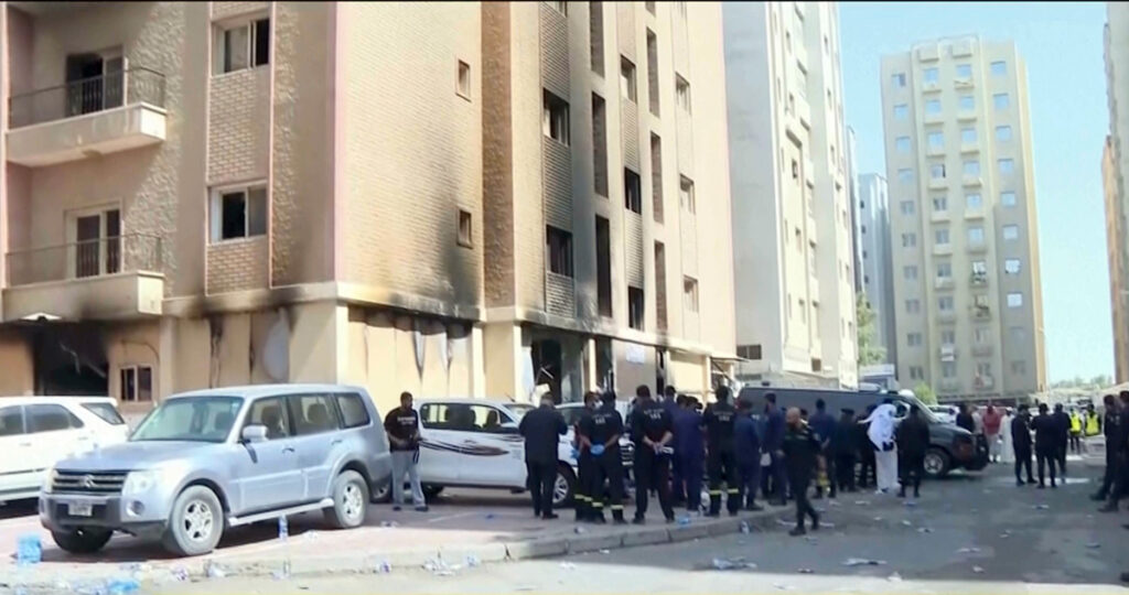 Rescuers arrive at the site of a building that caught fire in Kuwait, Wednesday, June 12, 2024. At least 41 people died when a fire swept through a building that housed workers in Kuwait early Wednesday.