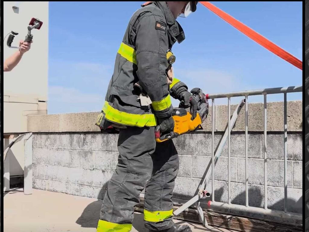 Firefighter cutting with a saw