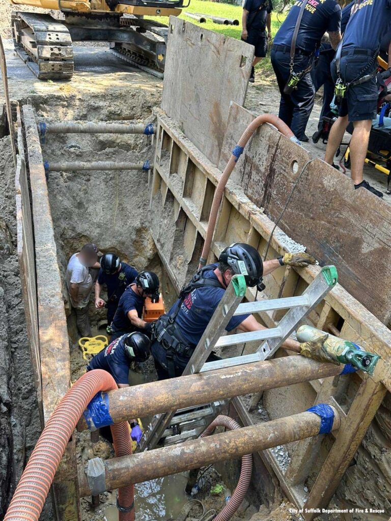 Firefighters on ladder during trench rescue