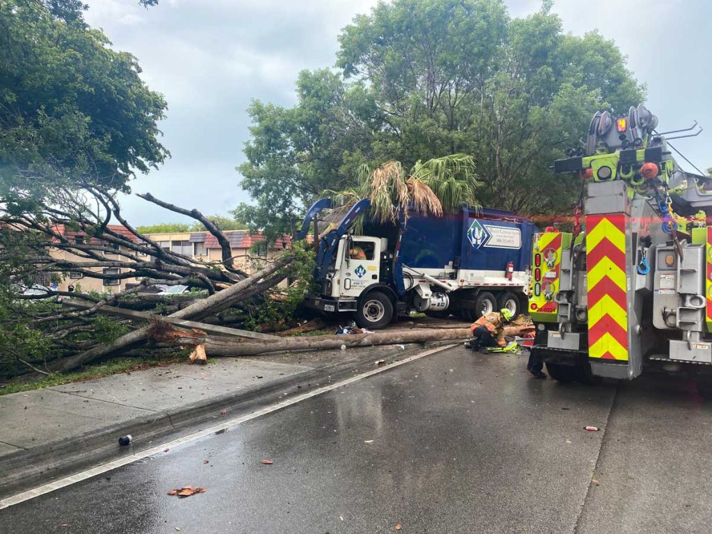 Miami Dade firefighters respond to crash of garbage truck into trees