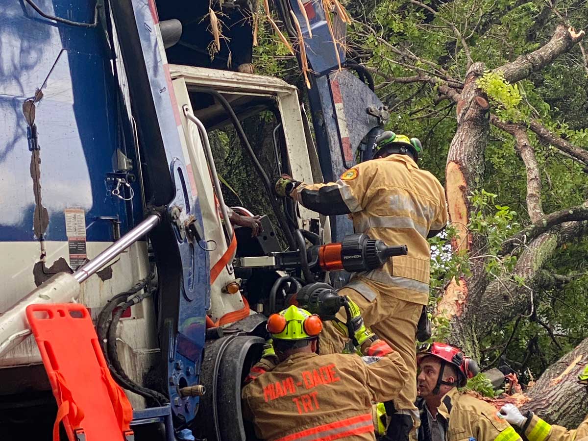 Miami Dade firefighters use hydraulic spreader at crash scene