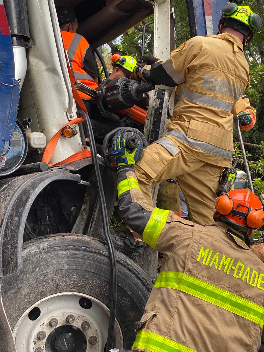 Miami Dade firefighters use hydraulic extrication equipment at crash