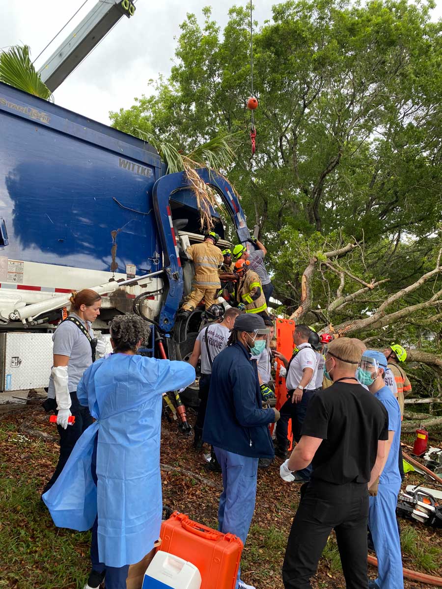 Miami Dade firefighters perform extrication with medical crews in foreground