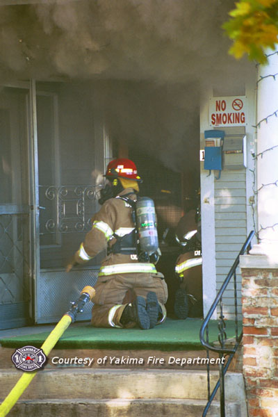 Firefighter make entry. Courtesy of the Yakima Fire Department.